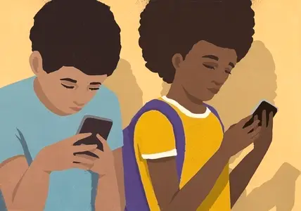 Schoolboy and schoolgirl using smart phones side by side