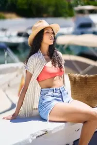 Summer Vibes A Young Woman Dressed in Trendy and Stylish Swimwear at a Beautiful Marina