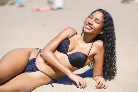 Joyful Summer Vibes A Young Woman Enjoying a Relaxing Day on the Beach Under the Sun