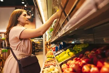 Female customer in a grocery store at shelves Female customer in a grocery store at shelves