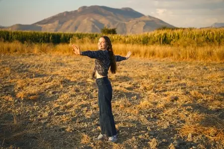 A Joyful Woman in the Embracing Nature Radiating Pure Happiness and Blissful Energy