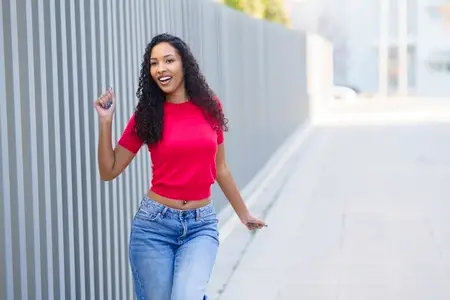 A Joyful and Energetic Young Woman Happily Walking in a Bright and Lively Urban Setting Full of Life