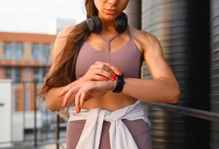 Close up of female hands and smartwatches  Cropped shot of a muscular sportswoman checking her pulse