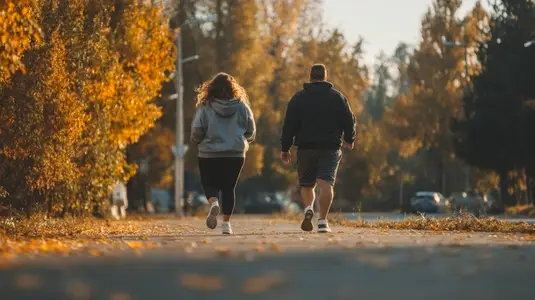 Overweight couple jogging together autumn park outdoor exercise healthy lifestyle motivation