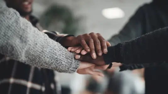 Teamwork support unity collaboration and trust shown by diverse hands stacked together Teamwork support unity collaboration and trust shown by diverse hands stacked together