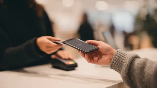 Contactless payment with smartphone at modern counter  secure transaction  blurred background
