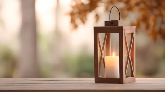 Wooden lantern candle glowing on table autumn outdoor peaceful warm light decor