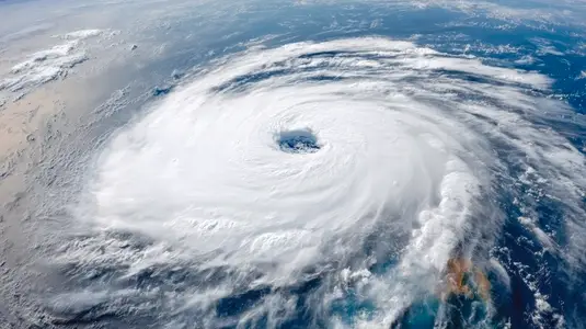 Cyclone storm eye  swirling cloud  ocean  dramatic weather  aerial view  powerful nature