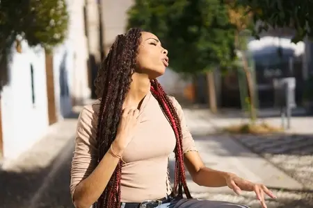 A Selfassured Young Woman Conveying Deep Emotion in a Vibrant Urban Environment