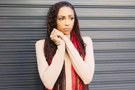 A Stylish Portrait of a Woman with Red Dreadlocks  Blending Contemporary Fashion and Urban Life