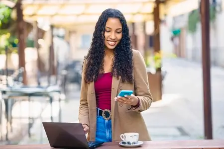 Young Professional Woman Working Remotely in a Caf