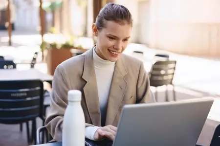A Young Professional is Working Remotely at a Charming Outdoor Cafe  Embracing the Environment