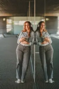 A Young Woman Wearing Headphones in a Contemporary and Modern Living Space Environment