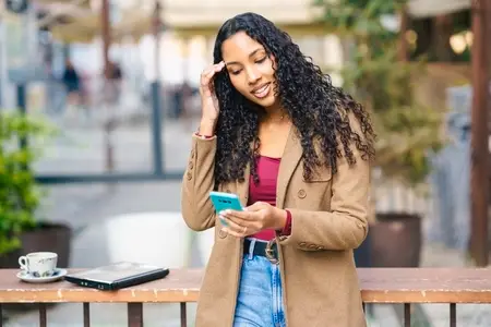 Young Woman Engaged with Smartphone in a Caf Setting