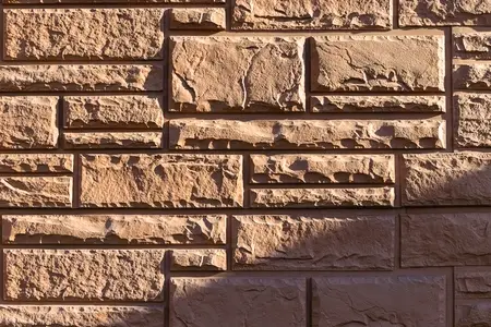 Close up of a decorative stone brick wall with textured surface and natural patterns