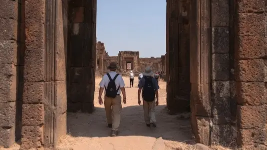 Tourist ancient temple ruin walking stone architecture travel historic outdoors