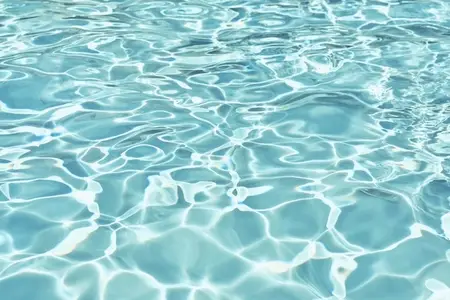 Full frame of sunlight reflecting on rippled turquoise blue surface