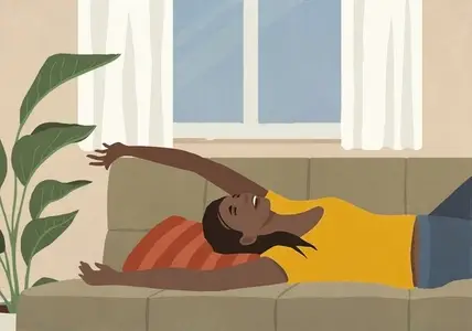 Happy carefree young woman relaxing laying on living room sofa