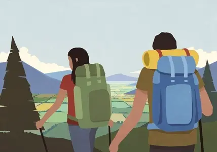 Young couple backpacking in mountains overlooking rural valley