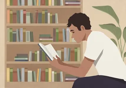 Young man reading book at home by bookcase