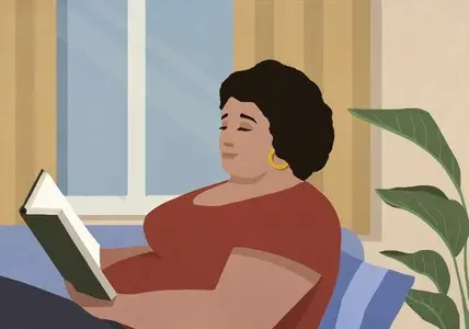 Woman relaxing reading book in living room