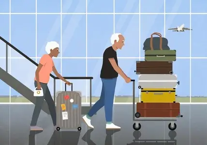 Active senior couple traveling pushing wheeled luggage and suitcase cart