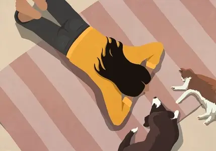 View from above woman relaxing on rug with pet dog and cat