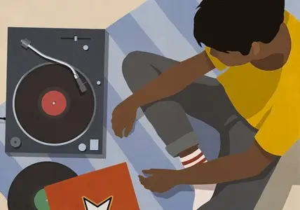 High angle view of young man listening to music at record player