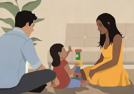 Parents playing with toddler daughter stacking wood blocks
