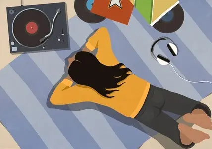 View from above young woman listening to music at record player