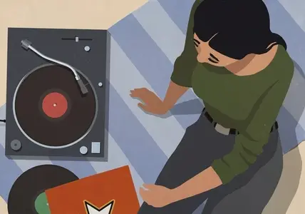 High angle view of woman listening to music at record player