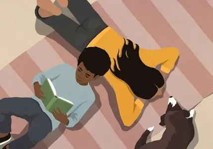 View from above boy reading book on floor by mom and pet dog