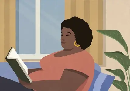 Serene woman reading book in living room at home