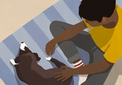 High angle view boy petting dog on rug