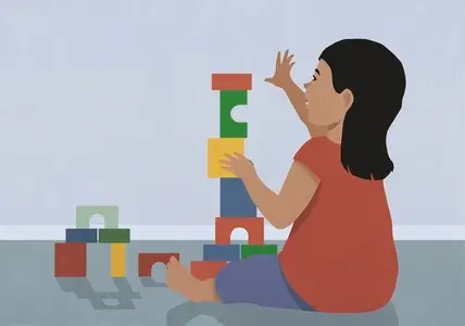 Toddler girl playing stacking toy blocks on floor
