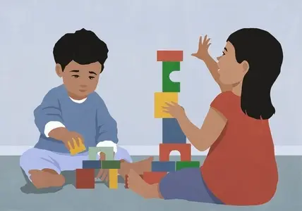 Toddler boy and girl stacking toy blocks on floor