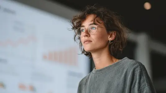 Businesswoman analyzing sales growth chart with focus and determination  showcasing professional environment and data driven