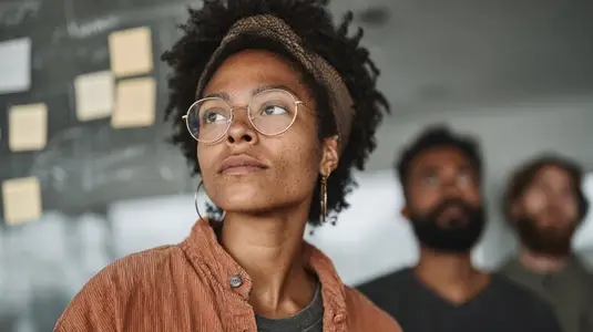 Diverse team brainstorming with sticky notes  focused expressions  collaboration  creativity  problem solving  teamwork