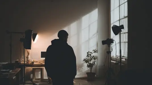 Photographer prepares for creative shoot well lit studio  showcasing blend of natural and artificial light  atmosphere is calm