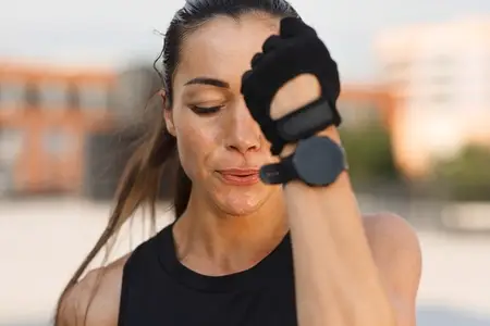 Close up high detailed portrait of young female in gloves doing shadow punches outdoors with closed eyes
