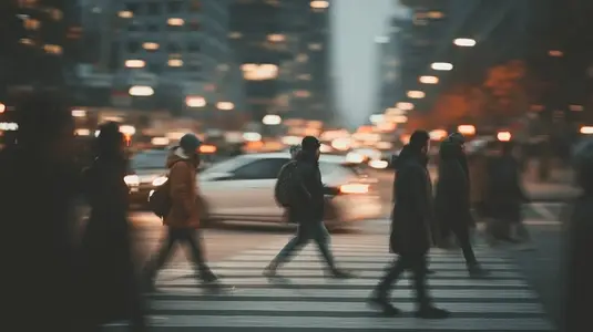 Commuters crossing busy street in downtown  blurred motion creates dynamic urban scene filled with energy and movement