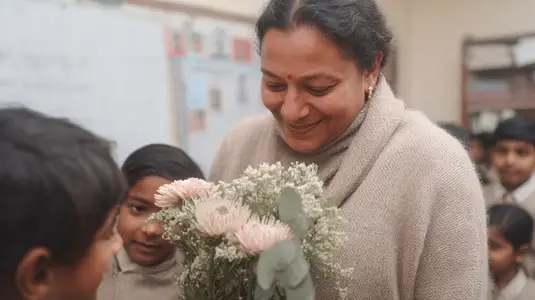 Celebration of Teachers Day in classroom with teacher receiving flowers from students  showcasing joy and appreciation