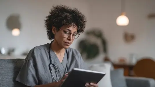 Healthcare professional using tablet for telehealth services cozy home environment  showcasing modern medical practices