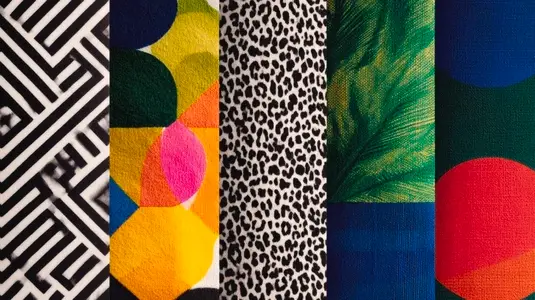 Vivid geometric patterns on fabric showcase high contrast designs in various colors  creating vibrant visual appeal