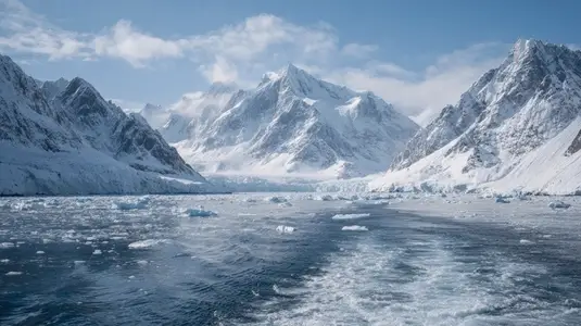 Majestic mountains surround serene glacial landscape  showcasing icebergs floating tranquil ocean  scene reflects beauty