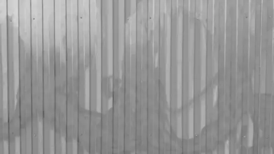 A close up view of a corrugated metal wall background