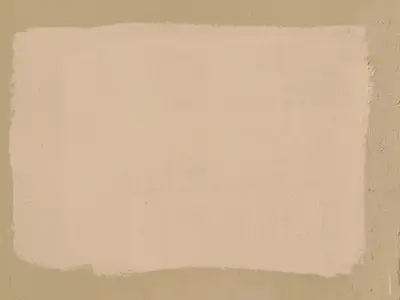 A textured wall background with a light beige paint patch square