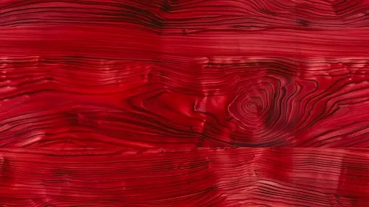 Seamless abstract red wood texture with swirling grain patterns